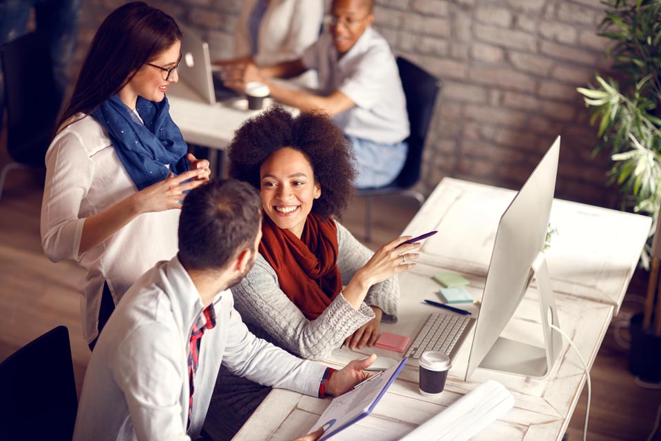 A diverse workforce pictured in an office environment that is veteran and disability friendly by Kinetic Business careers