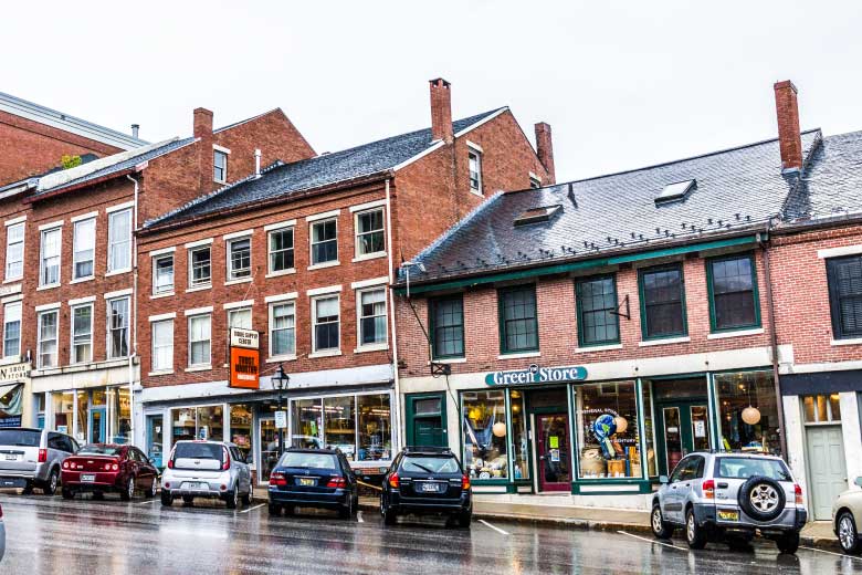 Cars parked in the street small town business section during heavy rain storm